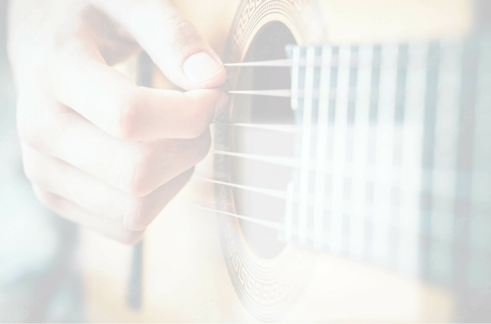 faded image of a man strumming an acoustic guitar